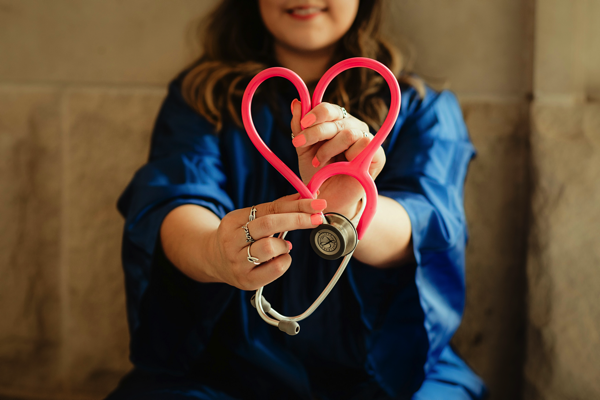 Image of a doctor holding a stethescope in the shape of a heart. Can doctor's really buy a house with only 5% deposit?